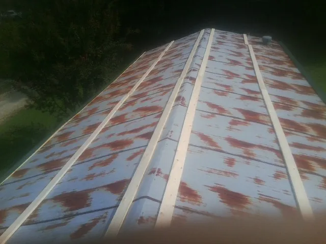 Rusted metal roof panels with new wood purlins before replacement — Storm Damage Roof Repair in Atlantic by Roofing Brothers